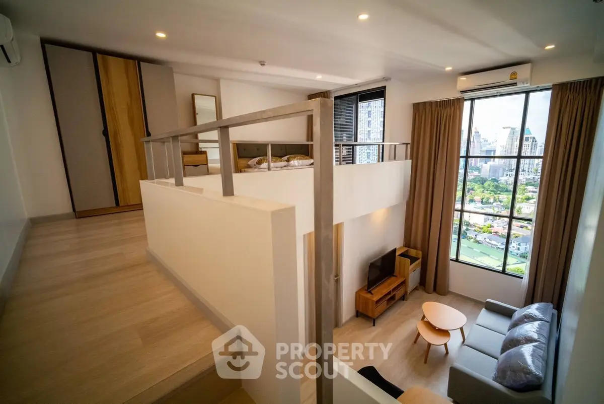 Modern loft apartment with large windows and city view, featuring stylish living area and cozy bedroom.