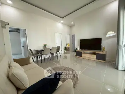 Modern living room with sleek furniture and open layout, perfect for entertaining.