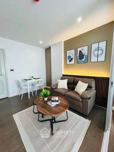 Modern living room with stylish decor, cozy sofa, and elegant dining area in a contemporary apartment.