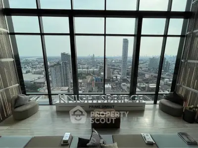 Luxurious high-rise living room with panoramic city view at Knightsbridge Prime Onnut.