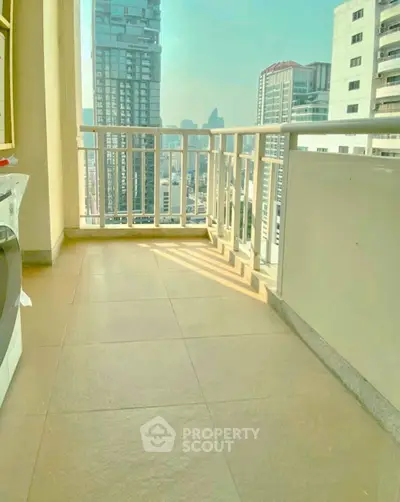 Spacious balcony with city skyline view in modern high-rise apartment
