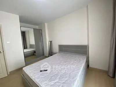 Spacious bedroom with modern design and large mirror wardrobe