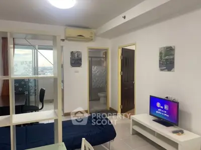 Modern studio apartment with city view, featuring cozy living area and compact design.