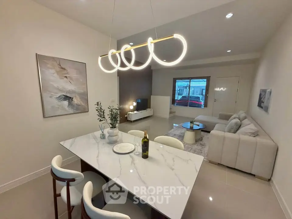 Modern living room with elegant dining area and stylish lighting in a contemporary home.
