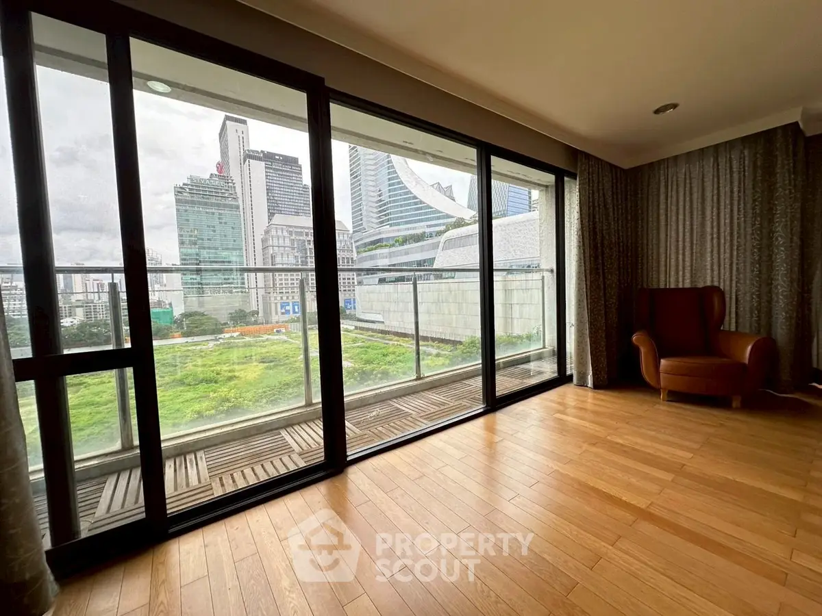 Spacious apartment with floor-to-ceiling windows offering stunning cityscape views.