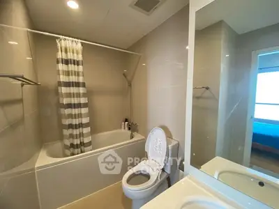 Modern bathroom with bathtub and shower in sleek apartment