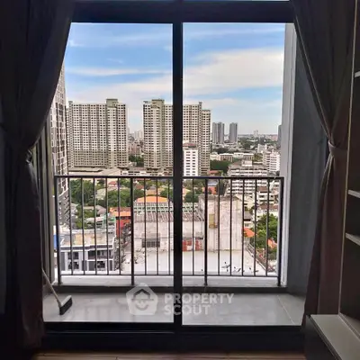 Stunning city view from a modern apartment balcony with sliding glass doors.