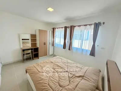 Bright and airy bedroom with modern furnishings and ample natural light.
