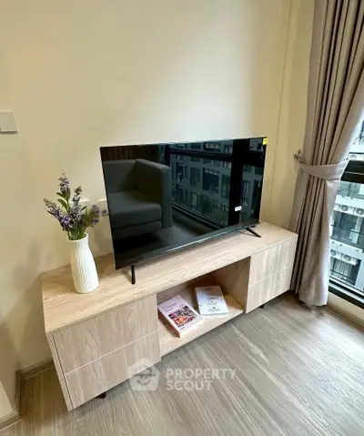 Modern living room with sleek TV stand and large window view