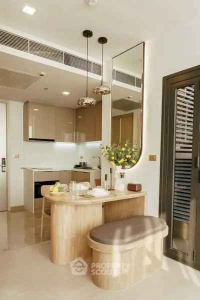Modern kitchen with open layout and stylish dining area in a contemporary apartment.