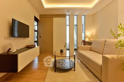 Modern living room with sleek furniture and ambient lighting in a stylish apartment.