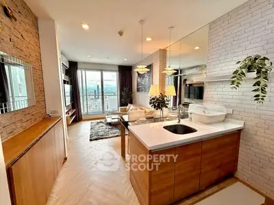 Modern open-layout living room with kitchen, featuring stylish decor and city view.