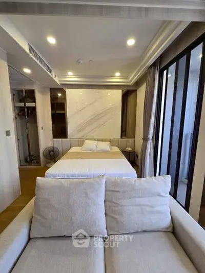 Modern bedroom with cozy sofa and stylish decor