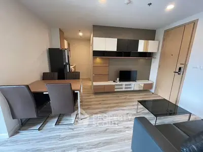 Modern living room with sleek furniture and open kitchen layout