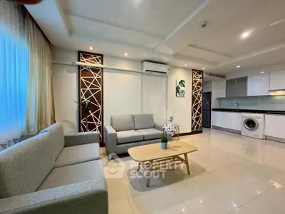Spacious modern living room with elegant decor and built-in kitchen appliances.