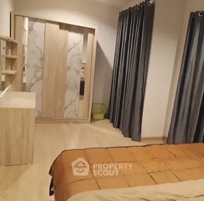 Modern bedroom with stylish wardrobe and cozy bedding