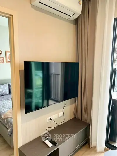 Modern living room with wall-mounted TV and air conditioning unit