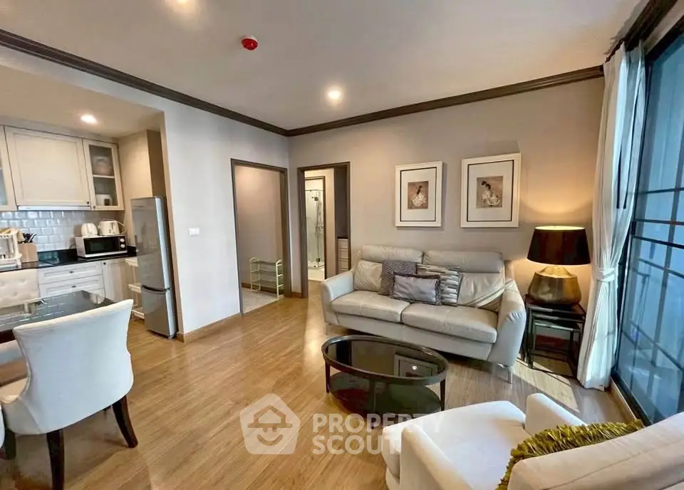 Modern living room with open kitchen and stylish decor in a cozy apartment.