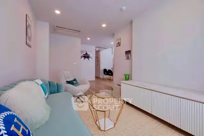 Modern living room with stylish furniture and elegant decor, featuring a cozy seating area and contemporary design.