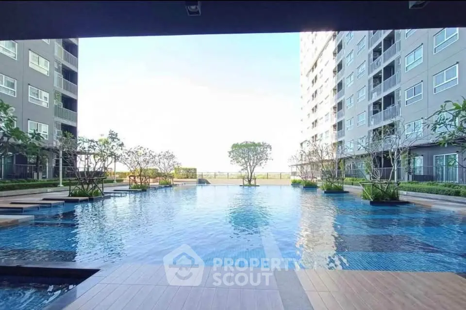 Luxurious apartment complex with stunning outdoor pool and modern architecture.