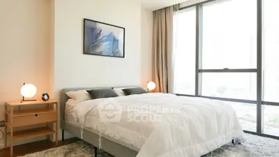 Bright and modern bedroom with large windows and stylish decor