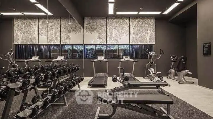 Modern gym with state-of-the-art equipment and stylish decor in luxury residential building.