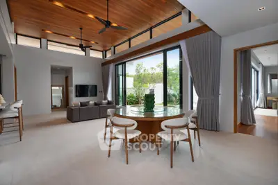 Luxurious open-plan living room with high ceilings and garden view