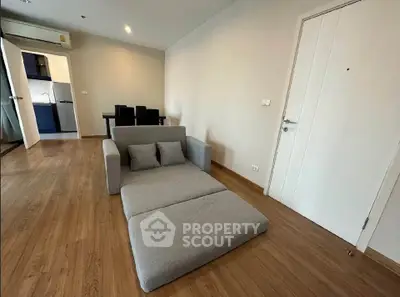 Modern living room with sleek gray sofa and wooden flooring