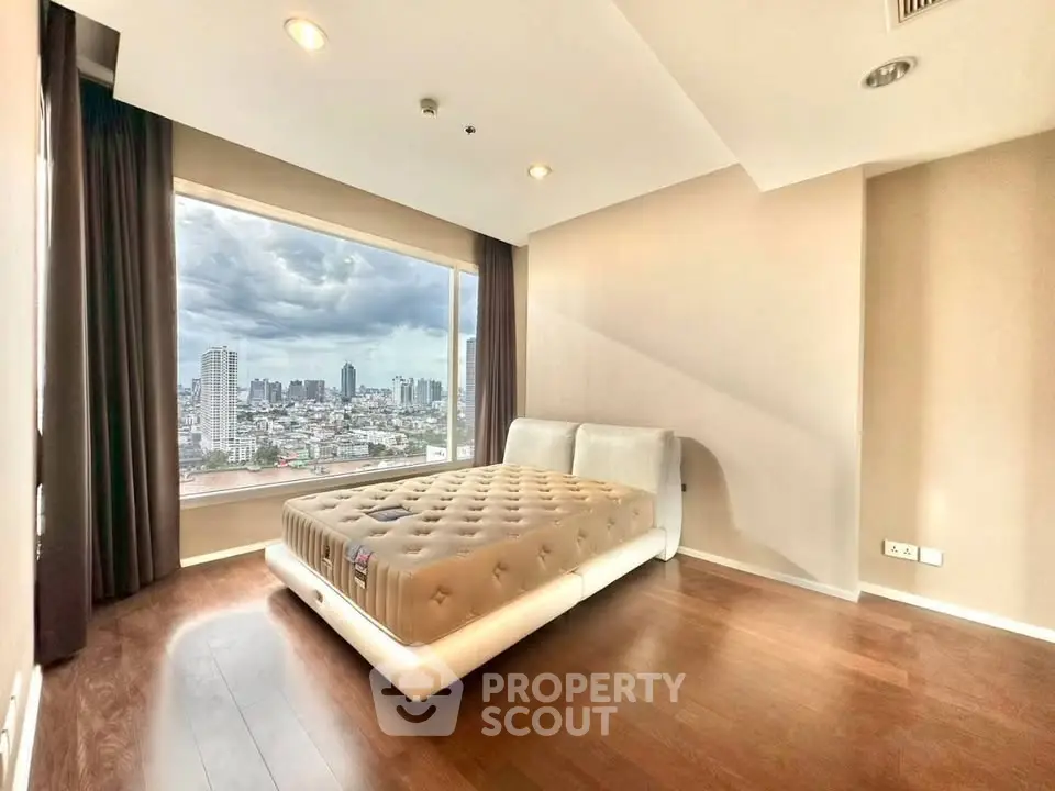 Spacious bedroom with city view and modern design in high-rise apartment