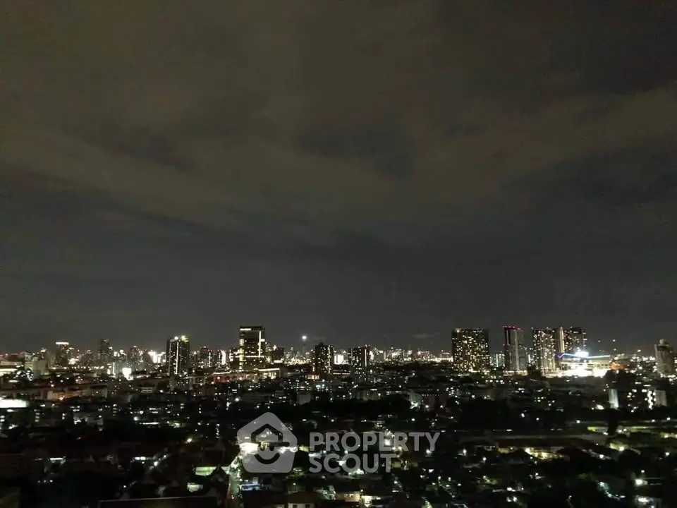 Stunning nighttime cityscape view showcasing vibrant skyline and illuminated buildings.