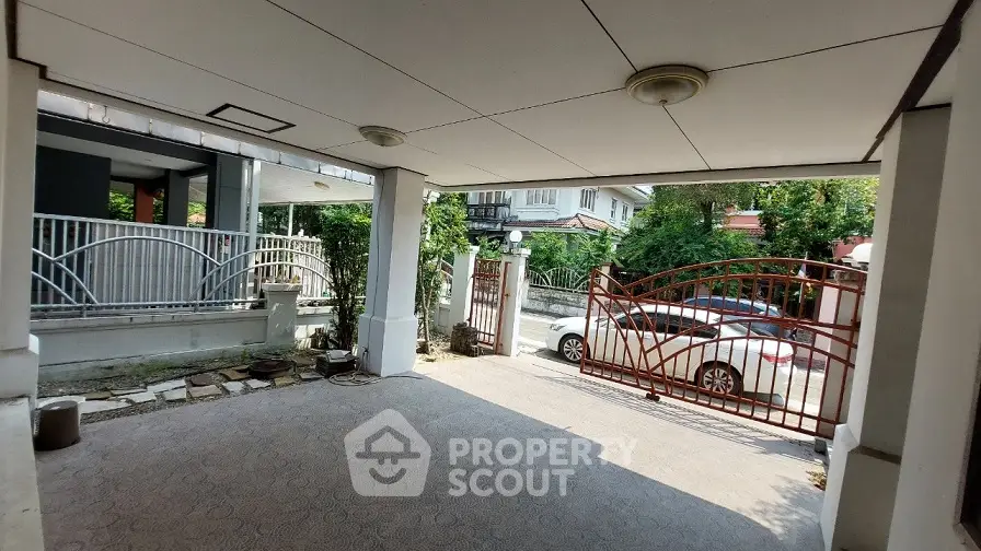 Spacious covered parking area with gated entrance in residential property