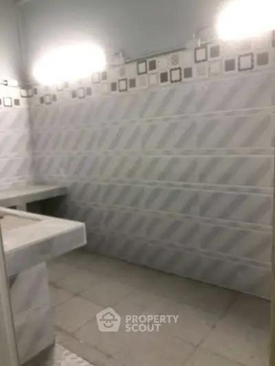 Modern bathroom with stylish tile design and ample lighting