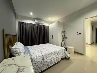 Modern bedroom with stylish decor and ample natural light