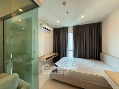 Modern bedroom with large window, air conditioning, and stylish furnishings in a contemporary apartment.