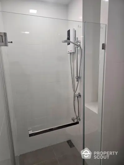 Modern bathroom with glass shower enclosure and sleek fixtures