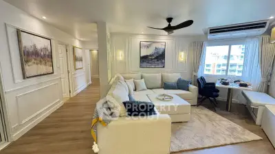 Spacious living room with elegant decor and large windows offering natural light.