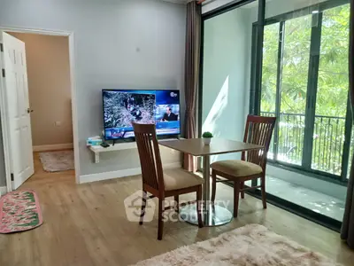 Cozy living room with dining area and balcony view