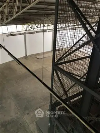 Spacious industrial warehouse with high ceilings and ample natural light.