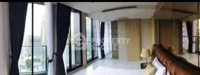 Luxurious bedroom with floor-to-ceiling windows offering stunning city views and elegant decor.