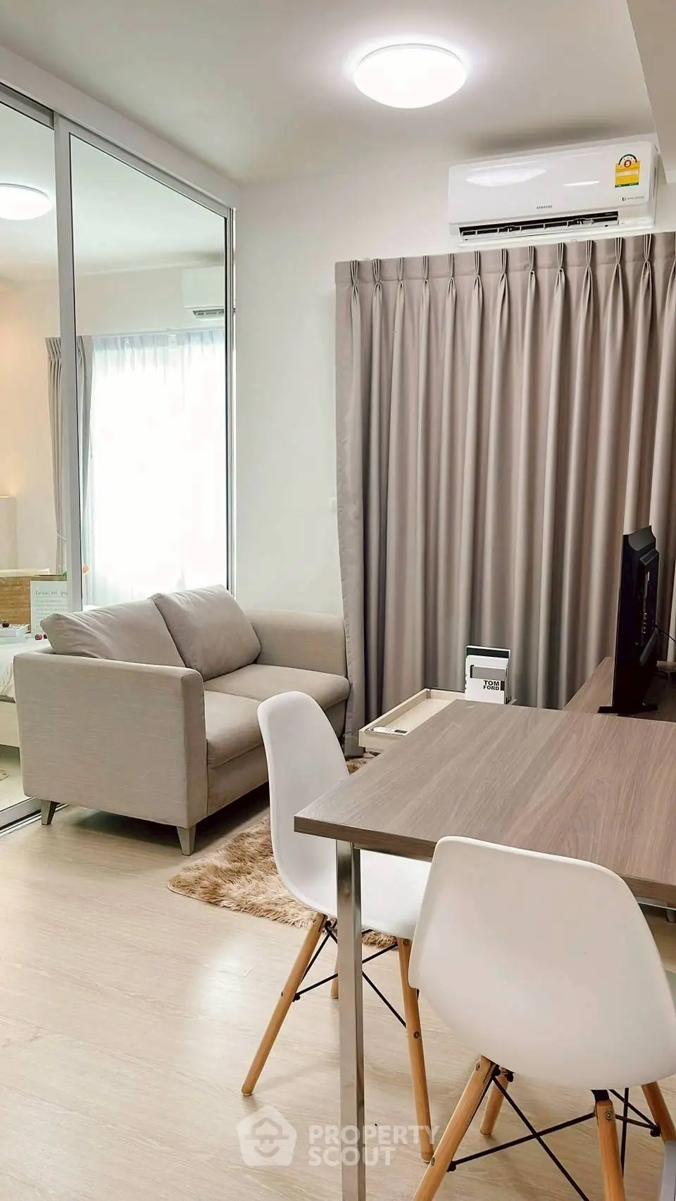 Modern living room with cozy sofa and stylish dining area in bright apartment.