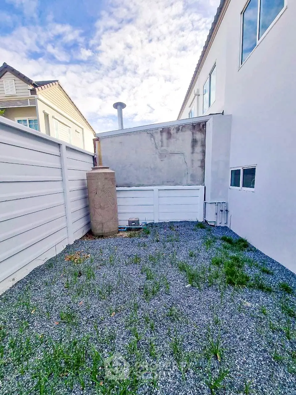 Charming backyard space with potential for landscaping in a suburban home setting.