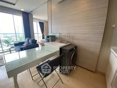 Modern apartment interior with washing machine and city view, featuring stylish furniture and ample natural light.