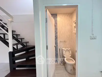 Modern bathroom with staircase view in a stylish duplex apartment