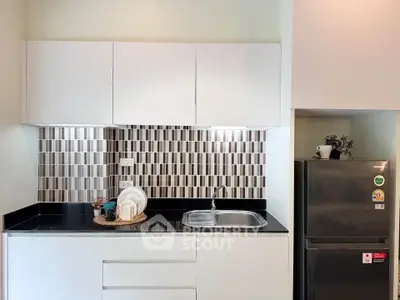 Modern kitchen with sleek cabinetry and stylish backsplash