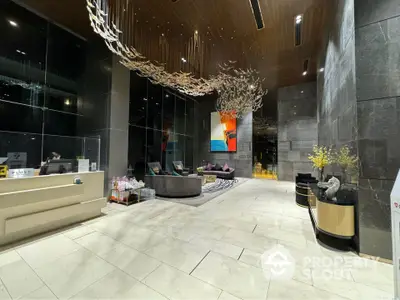 Luxurious modern lobby with artistic ceiling decor and elegant seating area