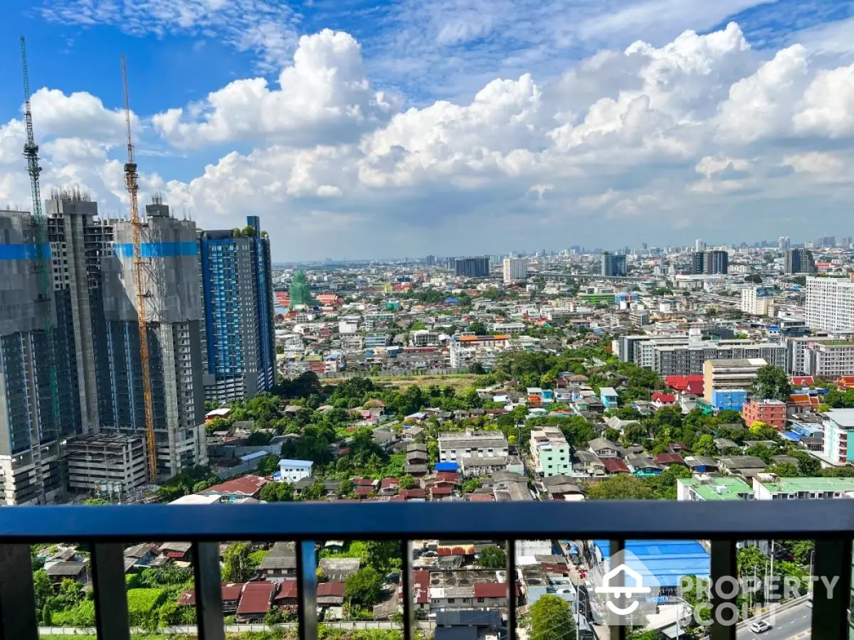 Stunning cityscape view from high-rise balcony with vibrant skyline and lush greenery.