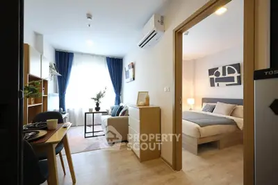 Modern apartment interior with cozy living room and stylish bedroom, featuring elegant decor and natural light.