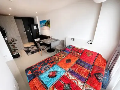 Modern studio apartment with vibrant decor and cozy dining area