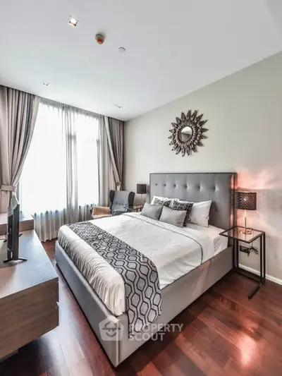 Luxurious bedroom with elegant decor and ample natural light