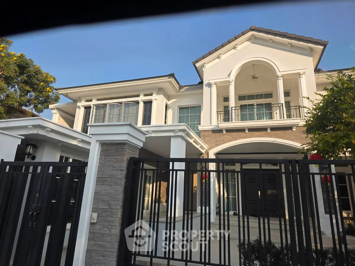 Stunning two-story luxury home with elegant facade and spacious balcony, perfect for upscale living.